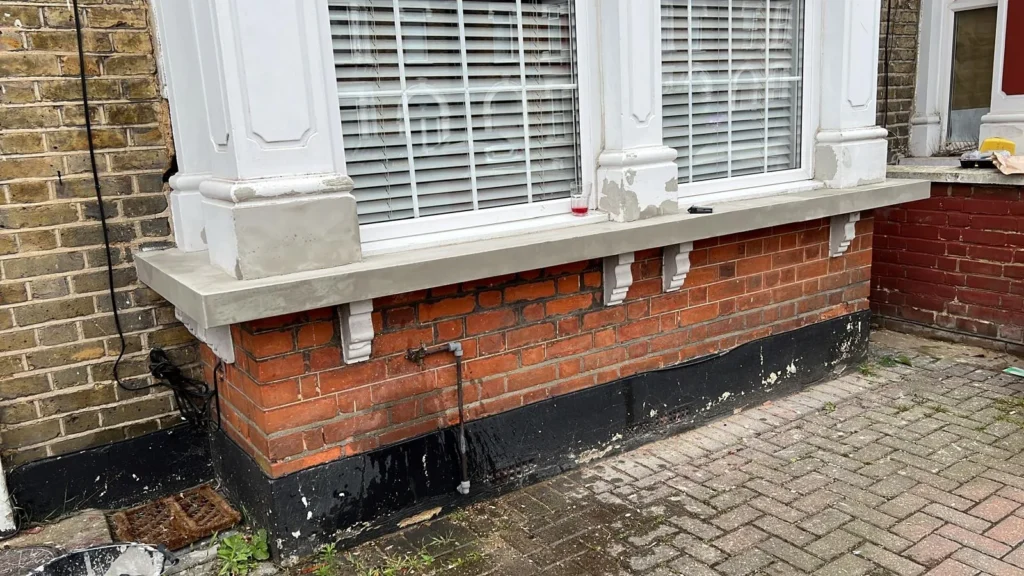 New rendered window sill and corbels drying on a bay window