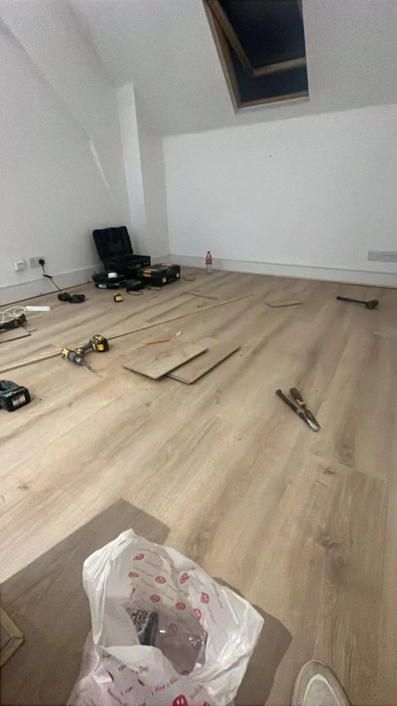 Light oak flooring being fitted in a loft room