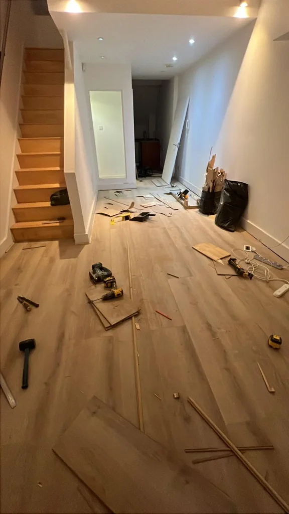 Oak flooring being fitted at the foot of a staircase