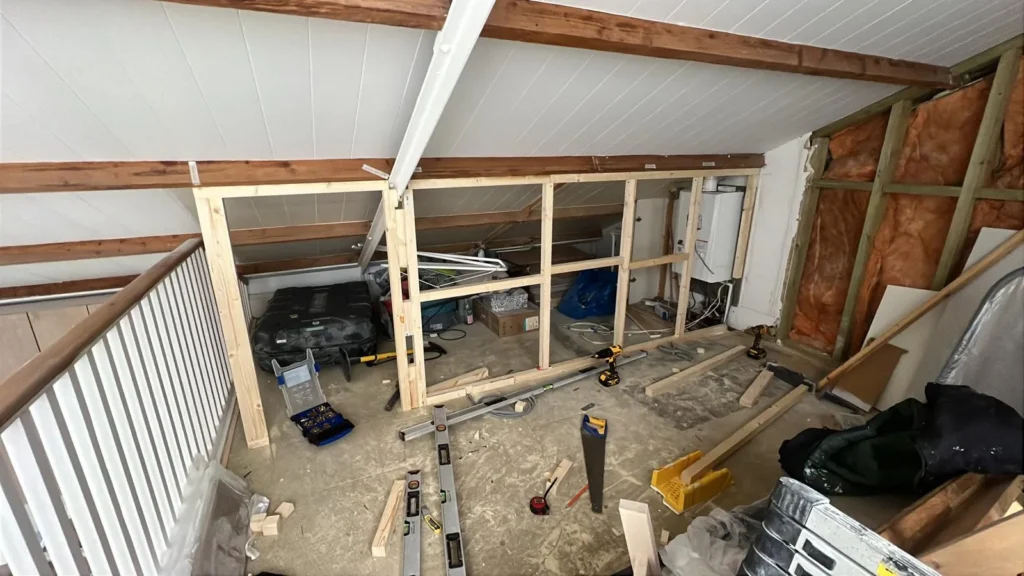 Timber framing for new loft partitions seen from the landing